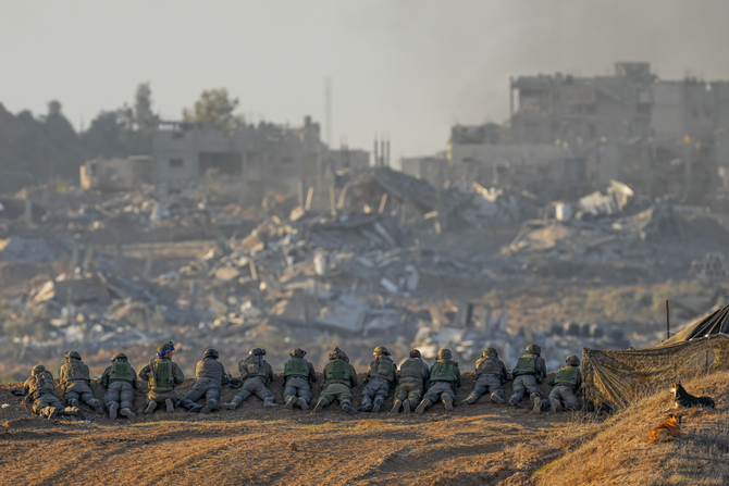Israeli soldiers take positions near the Gaza Strip border in southern Israel on Dec. 11, 2023, as the war with Palestinian militants continue. (AP Photo)