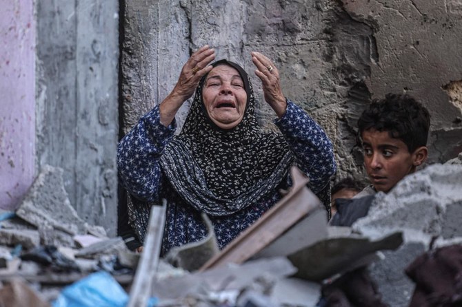 A Palestinian woman reacts following Israeli bombardment in Rafah, in the southern Gaza Strip, amid ongoing battles between Israel and the Palestinian militant group Hamas. (AFP)