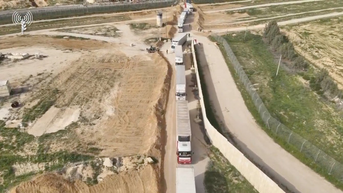 A still image from a video posted on X shows humanitarian aid trucks waiting in line to be inspected at the Kerem Shalom crossing on the border between Israel, Gaza and Egypt. (COGAT video/Handout via REUTERS)