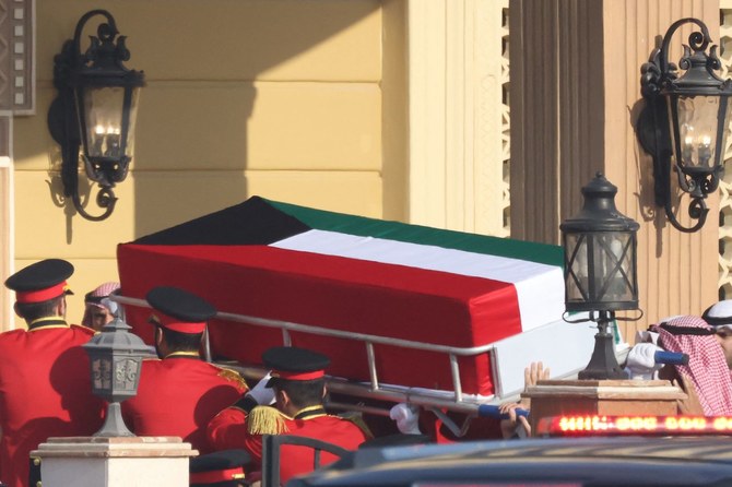 The coffin of Kuwait's late Emir Sheikh Nawaf al-Ahmad Al-Sabah is carried into the Bilal bin Rabah Mosque in Kuwait City during his funeral on December 17, 2023. (AFP)
