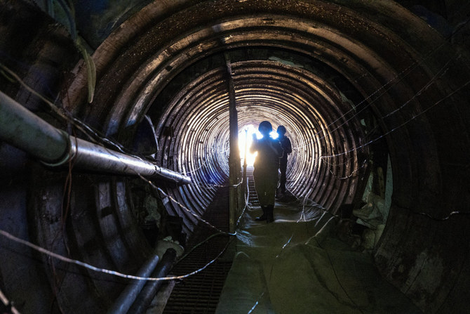 Israeli soldiers operate on December 15, 2023, in an iron-girded tunnel designed by Hamas to disgorge carloads of Palestinian fighters for a surprise storming of the border. (Reuters)