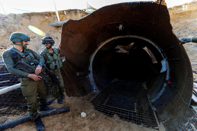 Israeli soldiers are seen near the opening of an iron-girded tunnel designed by Hamas to disgorge carloads of Palestinian fighters for a surprise storming of the border. (Reuters)