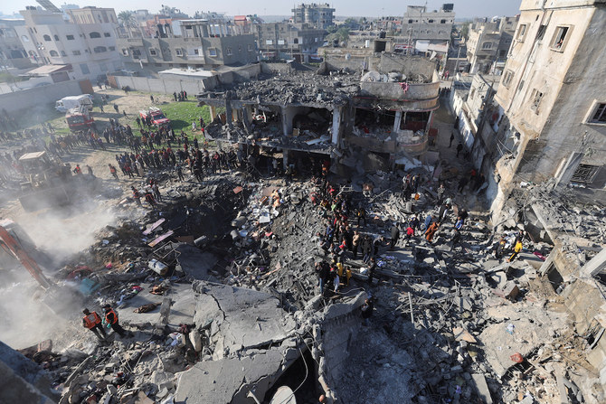 Palestinians gather at the site of an Israeli strike on a house in Rafah in the southern Gaza Strip on Dec. 19, 2023. (Reuters)