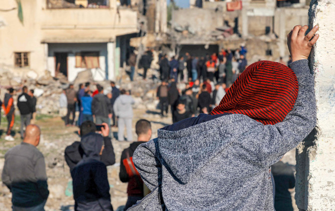 People gather to inspect the rubble of a building destroyed by Israeli bombardment in Rafah in the southern Gaza Strip on December 19, 2023 amid continuing battles between Israel and the militant group Hamas. (AFP)