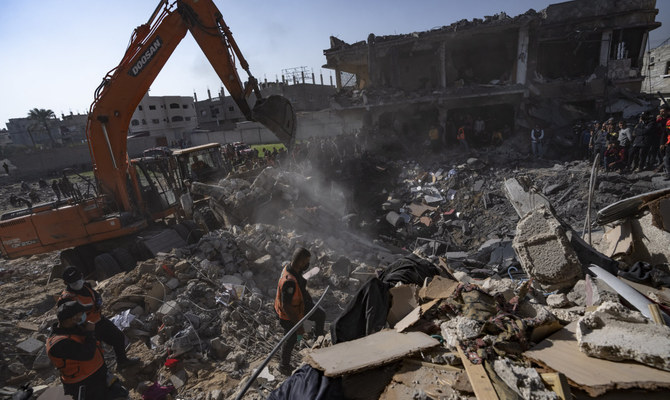 Palestinians search for bodies and survivors in the rubble of a residential building destroyed in an Israeli airstrike, in Rafah, southern Gaza Strip, Tuesday, Dec. 19, 2023. (AP)