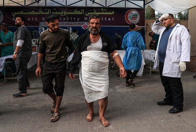 A man injured during Israeli bombardment looks on outside the Kuwait Hospital in Rafah in the southern Gaza Strip on Dec. 20, 2023. (AFP)