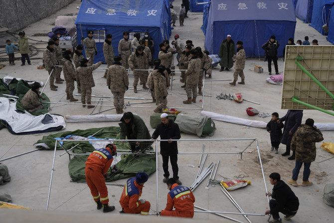 Soldiers and other volunteers help set up tents at a temporary shelter for residents on Dec. 20, 2023, following an earthquake in Dahejia town in northwestern China's Gansu province. (AP)