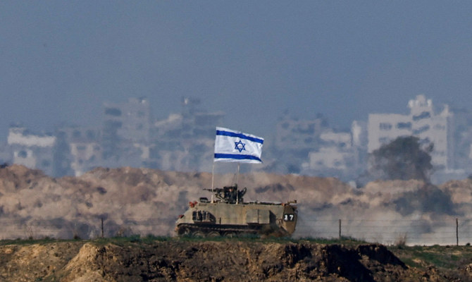 An Israeli military vehicle drives along the border with Gaza, amid the ongoing conflict between Israel and the Palestinian Islamist group Hamas, as seen from southern Israel, December 20, 2023. (Reuters)