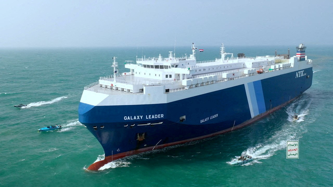 The Galaxy Leader cargo ship is escorted by Houthi boats in the Red Sea in this photo released on November 20, 2023. (Houthi media handout photo via REUTERS)