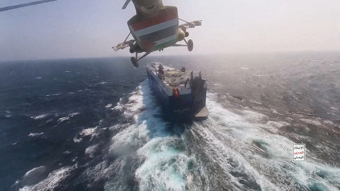 A Houthi military helicopter flies over the Galaxy Leader cargo ship in the Red Sea in this photo released November 20, 2023. (Houthi Military Media/Handout via REUTERS)