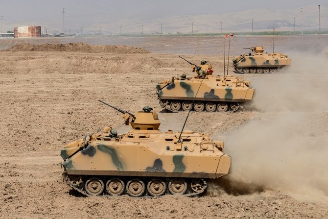 Turkish soldier ride armoured vehicles near the Habur crossing gate between Turkey and Iraq during a military drill. (AFP/File)