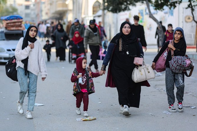 Residents of the refugee camp of Bureij arrive in Deir al-Balah in the central Gaza Strip following an evacuation order, on December 22, 2023. (AFP)