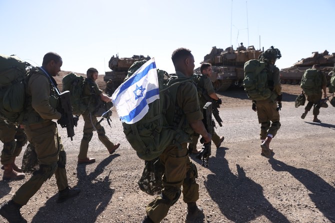 Israeli soldiers walk during a drill in the annexed Golan Heights on November 9, 2023, amid increasing cross-border tensions between Hezbollah and Israel as fighting continues in the south with Hamas militants in the Gaza Strip. (Photo by Jalaa MAREY / AFP)
