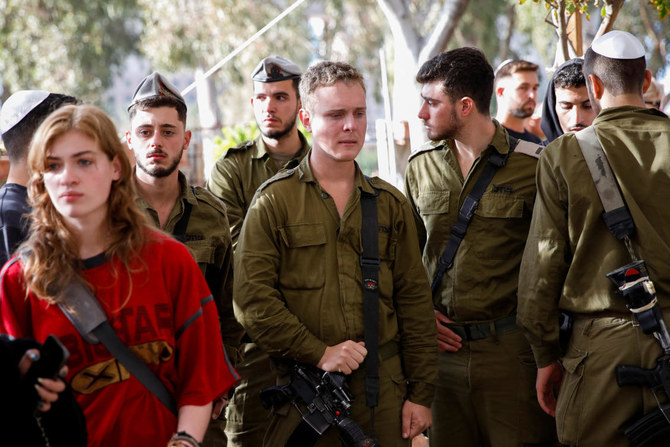 Mourners attend the funeral of Israeli soldier Staff sergeant David Bogdanovskyi, who was killed in the Gaza Strip during the Israeli army's ongoing ground operation amid the conflict with Palestinian Islamist group Hamas, at a cemetery in Haifa, Israel, December 24, 2023. (Reuters)