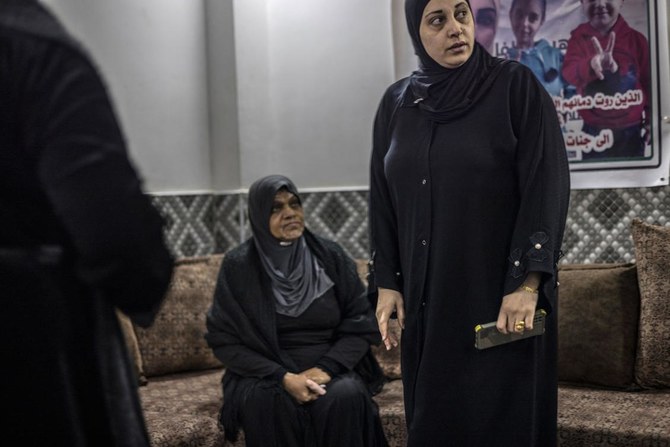 Mawaheb Marei, mother of 15-year-old Eid who was killed during an Israeli army operation, stands next to Ghada Marei, mother of 27-year-old Leena Marei, who was killed in Gaza. (AFP)