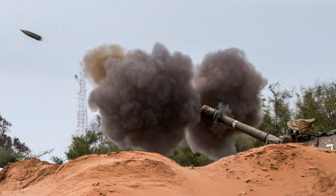 An Israeli army self-propelled artillery howitzer fires rounds from a position near the border with the Gaza Strip in southern Israel on December 24, 2023. (AFP)