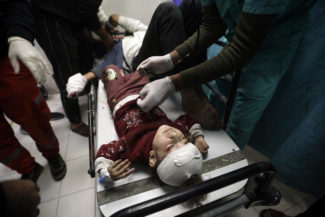 Palestinians wounded in Israeli airstrikes arrive at the Nasser hospital in the town of Khan Younis, southern Gaza Strip. Saturday, Dec. 23, 2023. (AP Photo/Mohammed Dahman)