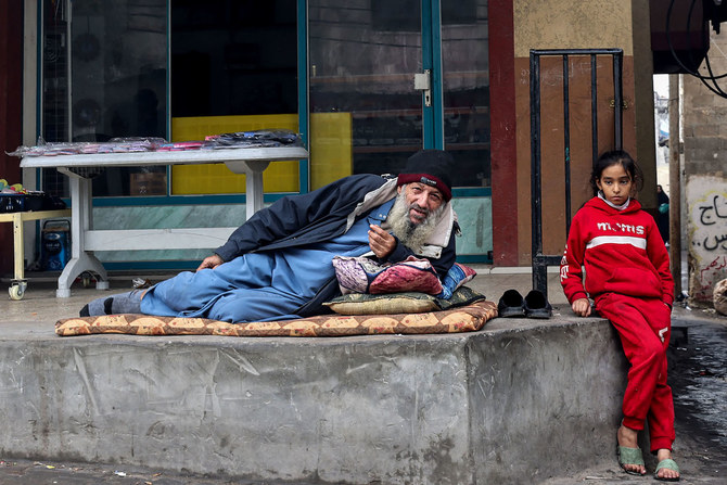 A displaced Palestinian man and child are pictured in Rafah in the southern Gaza Strip on Dec. 27, 2023. (AFP)