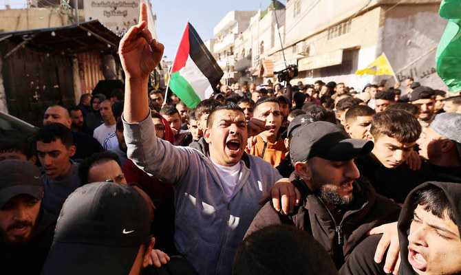 Mourners attend the funeral procession of two men killed in an Israeli army incursion in the Al-Fawwar refugee camp, south of Hebron in the West Bank, on Tuesday. (AFP)