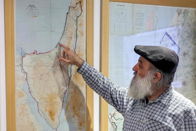 Oded Mizrachi, a former Israeli settler in the Gush Katif, points to map showing Gaza Strip among areas occupied by Israel after the 1967 Six-Day War including the Sinai peninsula, the Golan Heights, the West Bank, and East Jerusalem (File/AFP)