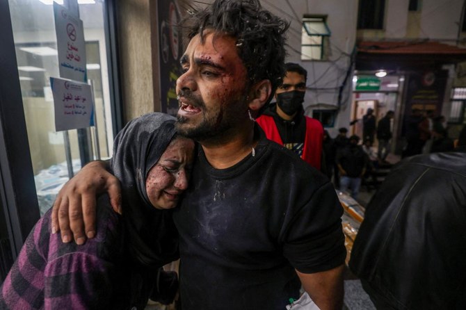 Victims of an Israeli army strike react outside of Kuwait hospital in Rafah in the southern Gaza Strip following on December 28, 2023, as battles continue between Israel and the Palestinian Hamas movement. (AFP)