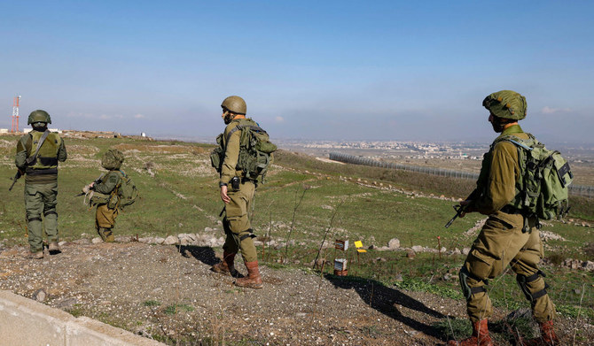 Israeli soldiers man a position in the Israel-annexed Golan Heights near the border with Syria on December 28, 2023. (AFP)
