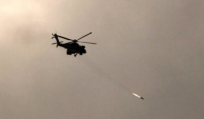 A picture taken from a position in southern Israel along the border with the Gaza Strip on December 29, 2023 shows an Israeli military helicopter firing a missile towards Gaza amid continuing battles between Israel and the militant group Hamas. (AFP)