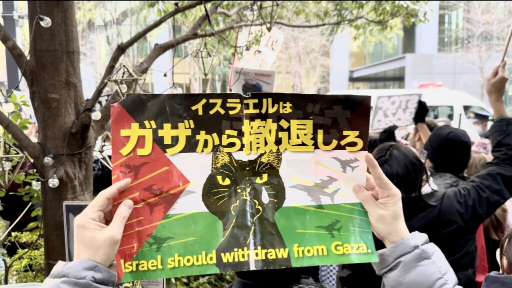 One demonstrator told Arab News Japan that they had planned to stand facing the embassy's main gate, but the police prevented them and only allowed them a spot on the side street of the compound. (ANJ)