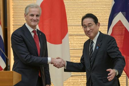Norway's Prime Minister Jonas Gahr Store (left) shakes hands with Japan's Prime Minister Fumio Kishida after speaking to the media following their bilateral meeting at the prime minister's official residence in Tokyo on December 7, 2023. (AFP)