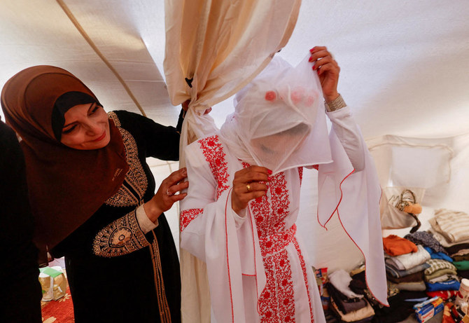 A Palestinian bride, Shahad, adjusts her veil in a tent camp, amid the ongoing conflict between Israel and Hamas, on her wedding day, in Rafah on Jan. 18, 2024. (Reuters)