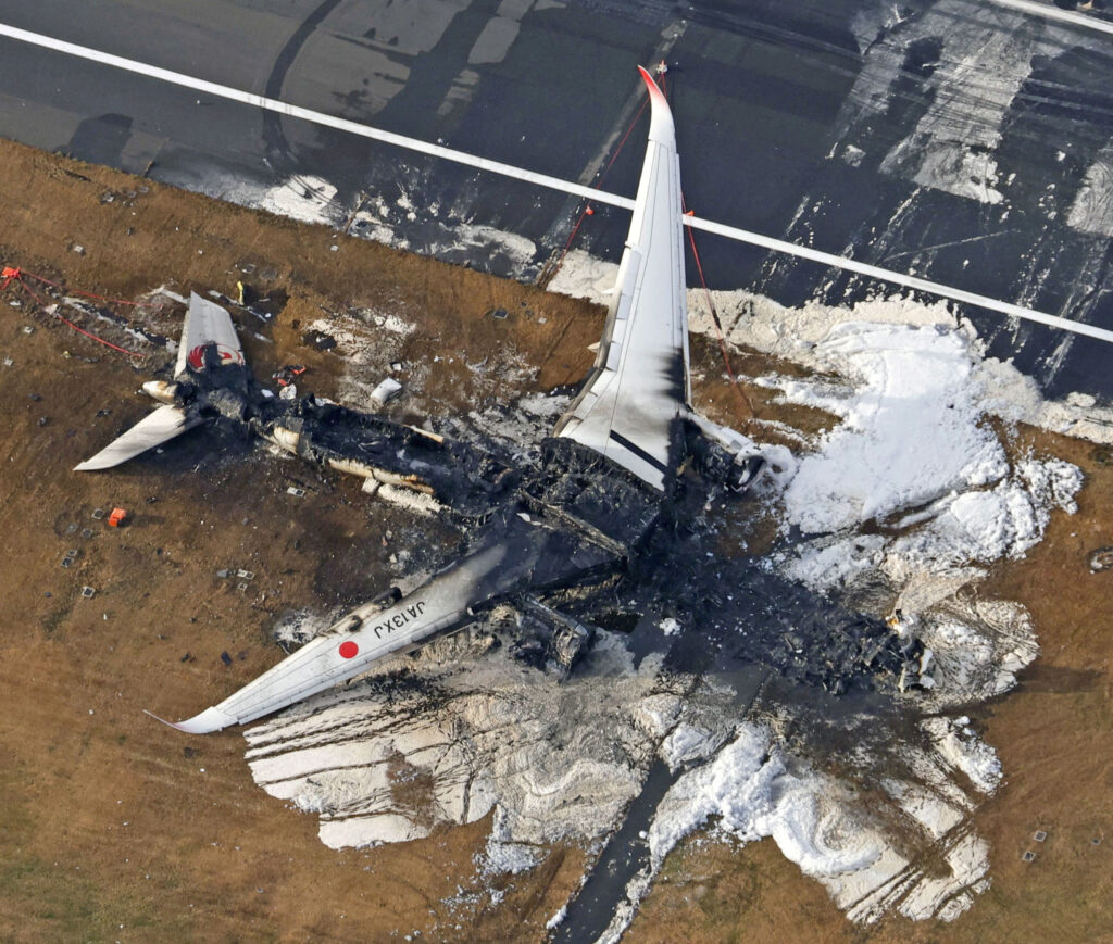 An aerial view shows burnt Japan Airlines' (JAL) Airbus A350 plane after a collision with a Japan Coast Guard aircraft at Haneda International Airport in Tokyo, Japan January 3, 2024, in this photo taken by Kyodo. (Kyodo/via REUTERS)