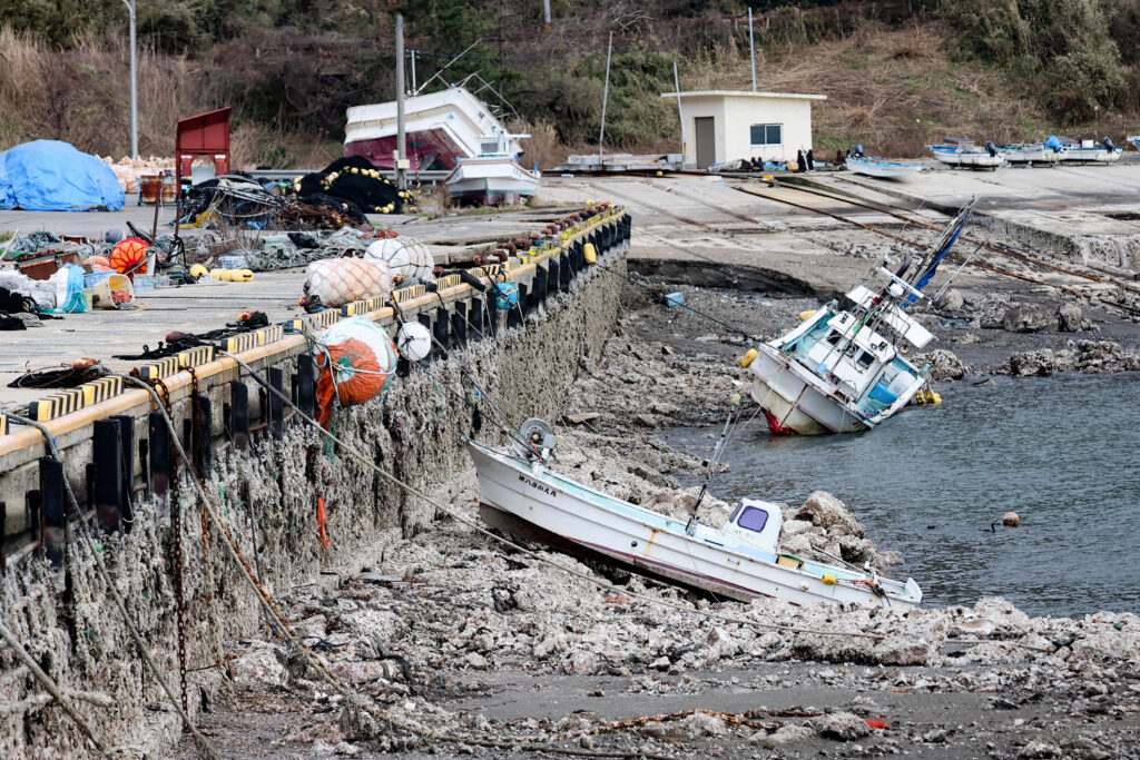 The 7.5-magnitude jolt on New Year's Day and its powerful aftershocks killed at least 215 people in the central Ishikawa region, flattening houses, wrecking infrastructure and leaving thousands without power. (Photo by JIJI PRESS / AFP)