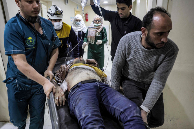 An injured man is rushed to receive medical care in the aftermath of reported bombardment by Syrian government forces, at a hospital in the rebel-held city of Idlib in northwestern Syria on December 30, 2023. (AFP)