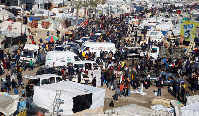 Palestinians gather at a tent camp sheltering displaced people, amid the ongoing conflict between Hamas and Israel, in Rafah, southern Gaza Strip, December 31, 2023. (REUTERS)
