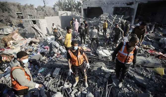 Palestinians inspect the damage of a destroyed house following Israeli airstrikes on Khan Younis, southern Gaza Strip, on Sunday. (AP)