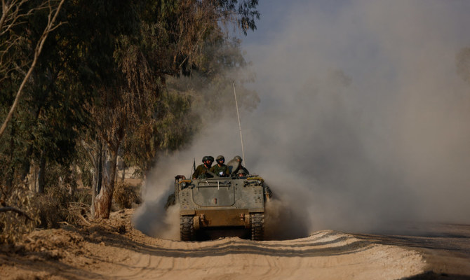 Israeli armoured personnel carrier (APC) maneuvers along the border with central Gaza, amid the ongoing conflict between Israel and the Palestinian Islamist group Hamas, in southern Israel, January 1, 2024. (Reuters)