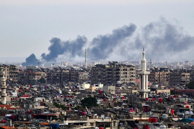 Smoke billows above buildings after an Israeli strike on the outskirts of Damascus on November 22, 2023.(AFP)