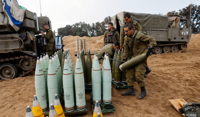 Israeli soldiers prepare shells near a mobile artillery unit, amid the ongoing conflict between Israel and the Palestinian Islamist group Hamas, in Israel, January 2, 2024. (REUTERS)