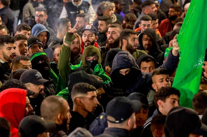 Palestinian Hamas suporters in the West Bank city of Ramallah protested on Jan. 2, 2024, against the Israeli strike in Lebanon that killed Hamas’ deputy leader Saleh Al-Aruri earlier. (AFP)