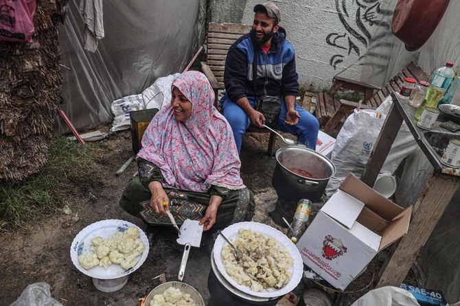 Displaced Palestinians cook a meal inside their shelter at the zoo in Rafah in the southern Gaza Strip, on January 2, 2024, where they sought refuge amid the ongoing conflict between Israel and the militant group Hamas. (AFP)