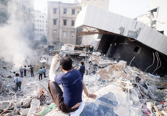 Picture dated 20 August 1982 of a man sitting on rubbles in a desolated area of west Beirut. (AFP/File)