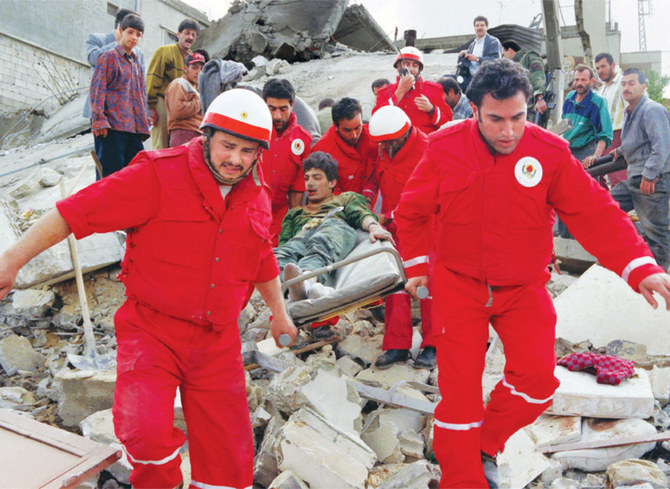 Rescuers carry a young victim of a stretcher on April 18, 1996 after an Israeli warplane bombed a house sheltering a family of eleven in the southern town of Nabatiyeh, killing a mother and her eight children.(AFP/File)