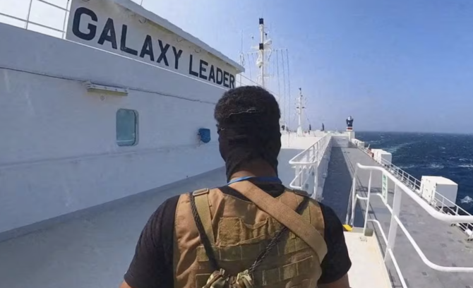 A Houthi fighter stands on the Galaxy Leader cargo ship in the Red Sea in this photo released November 20, 2023. (Houthi Military Media via Reuters)