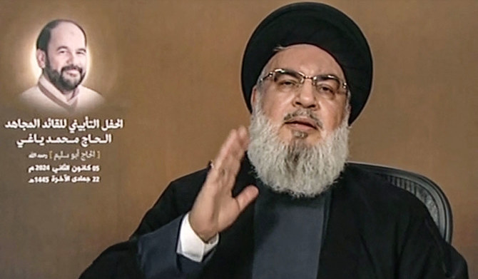 An image grab from Hezbollah's Al-Manar TV taken on January 5, 2024, shows the head of the Lebanese Shiite movement Hezbollah Hassan Nasrallah delivering a televised speech, with a picture of killed Hamas's deputy chief Saleh al-Aruri to his left. (AFP)