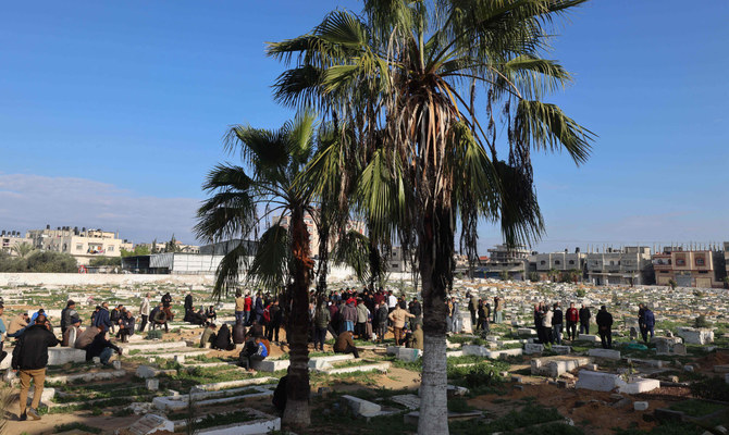 People bury their dead on January 5, 2024, in Rafah on the southern Gaza Strip following Israeli bombardment, amid continuing battles between Israel and the Palestinian militant group Hamas. (AFP)
