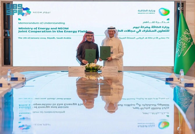 Saudi Energy Minister Prince Abdulaziz bin Salman, right, with NEOM CEO Nadhmi Al-Nasr after signing a memorandum of understanding. SPA