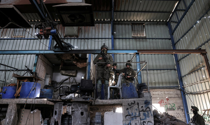 Israeli soldiers inspect what the Israeli army said is a steel factory where rockets and other ammunition was produced, as they operate, amid the ongoing conflict between Israel and the Palestinian Islamist group Hamas, in Gaza, January 8, 2024. (Reuters)