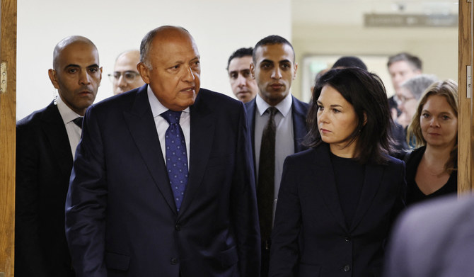German Foreign Minister Annalena Baerbock (2nd-R) walks with her Egyptian counterpart Sameh Shoukry (3rd-L) after their meeting in Cairo on January 9, 2024, amid continuing battles between Israel and the Palestinian militant group Hamas in Gaza. (AFP)