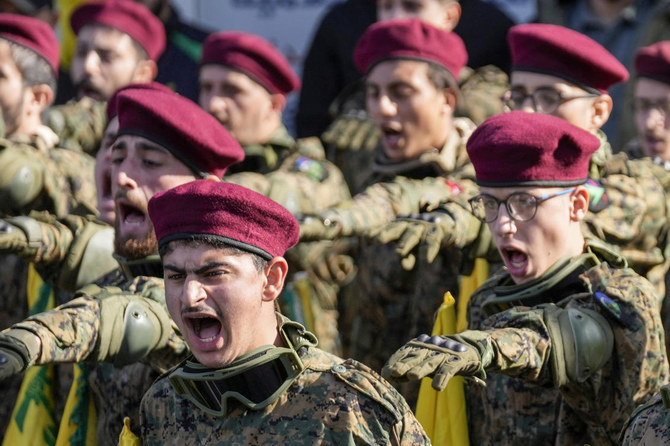 Hezbollah fighters chant slogans as they attend the funeral procession of senior Hezbollah commander Wissam Tawil, during his funeral procession in the village of Khirbet Selm, south Lebanon. (AP)