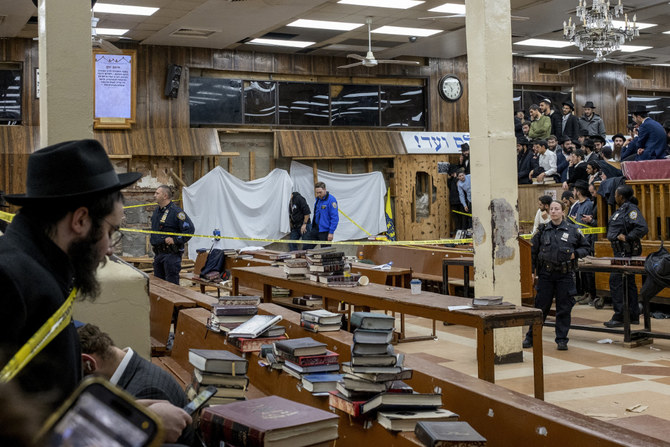 Hasidic Jewish students observe as law enforcers set up a perimeter around a breached wall in the synagogue that led to a tunnel dug by students in New York on Jan. 8, 2024. (Bruce Schaff via AP)